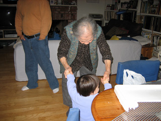 Ah-zho helping 15 month old Eleanor to walk.